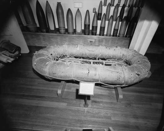 A Carley lifeboat, the sole relic of HMAS Sydney's last engagement, damaged by machine gun and shellfire, with two empty lifebelts lying in it (AWM 135152).