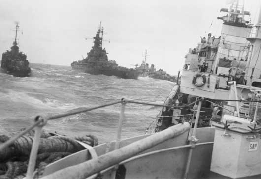 A US Navy battleship and escort destroyer photographed from HMAS Norman (AWM 121169).