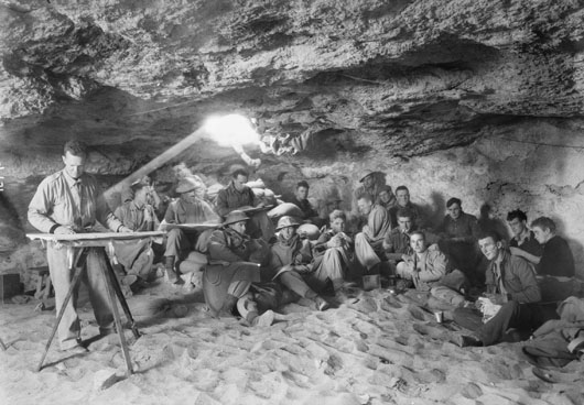 Maj. Peters, O.C., discussing plans with gun crews and officers before the attack on Bardia (AWM 004951).