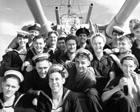 A group of happy crewmembers relaxing on HMAS Perth (AWM 006846).